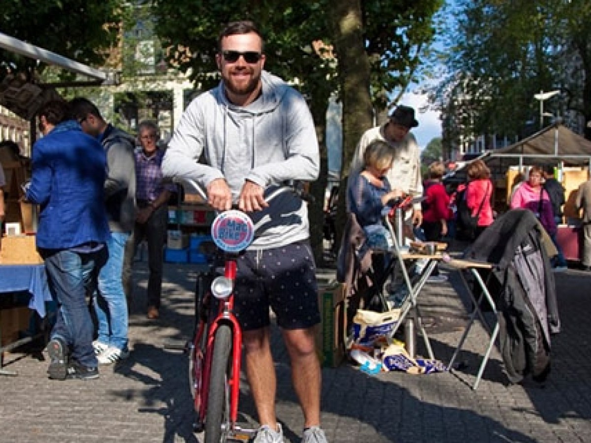 a group of people riding on the back of a bicycle