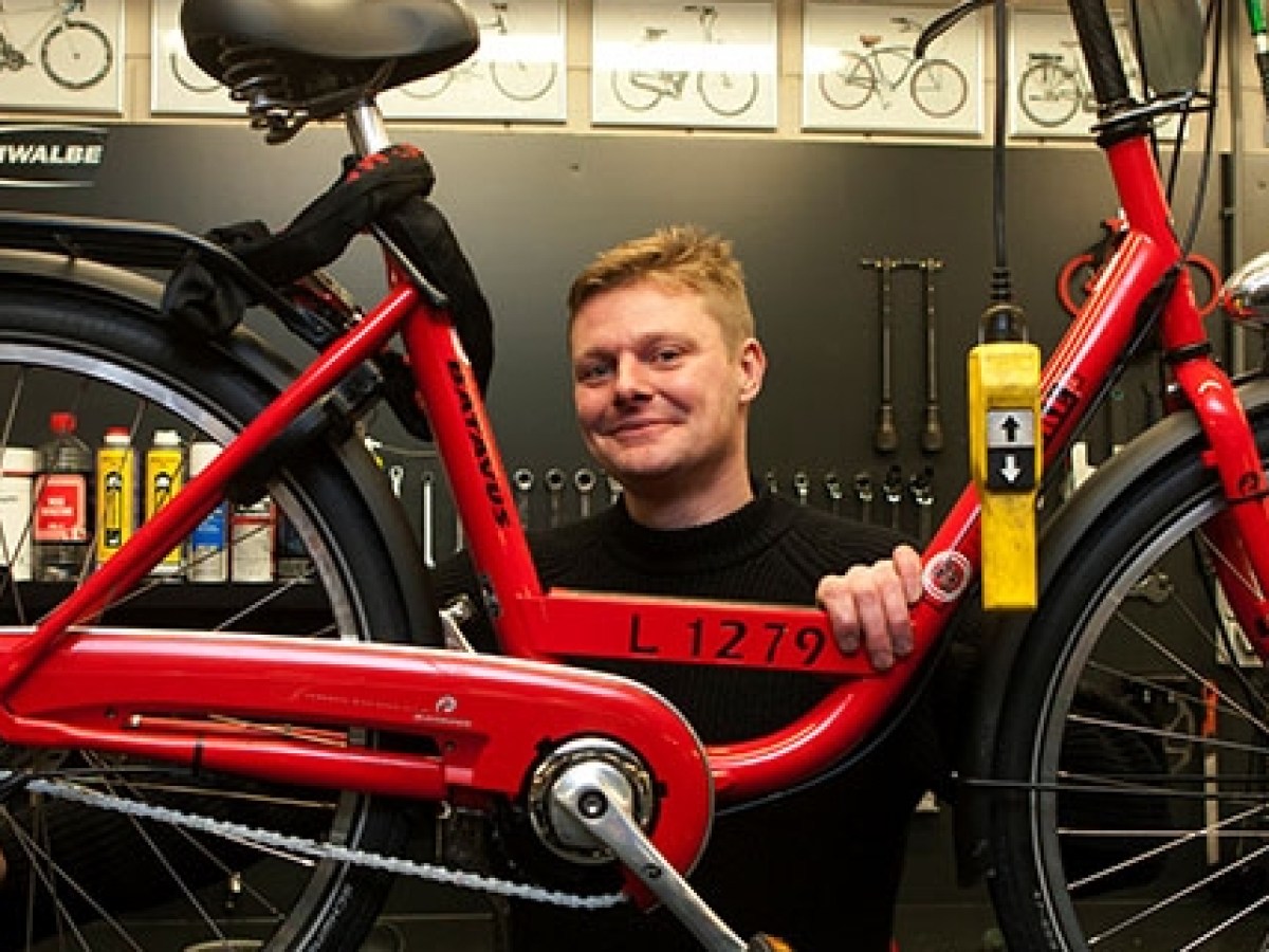 a red bicycle sitting next to a person