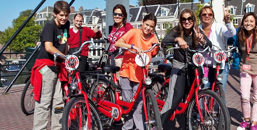 MacBike-group-MagereBrug-845×430-845×430 a group of people riding on the back of a bicycle