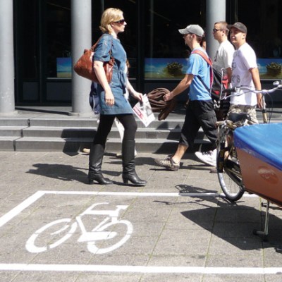 a group of people walking on a city street