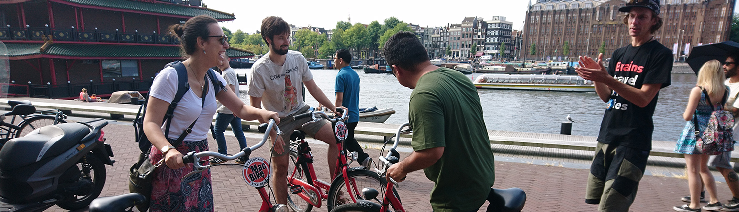MacBike-bedrijfsuitjes-Amsterdam-Teambuilding2_1500x430 a group of people riding on the back of a bicycle