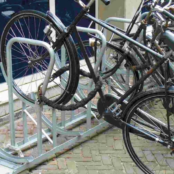a bicycle is parked next to a brick wall