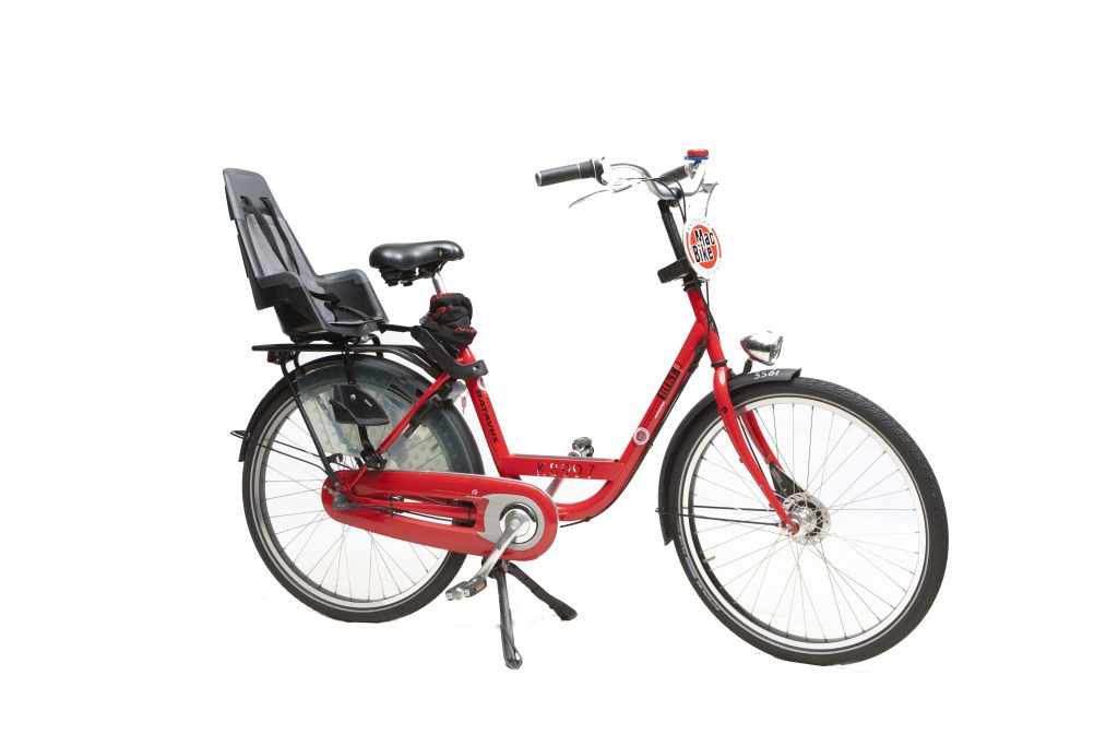 a bicycle leaning against a wall